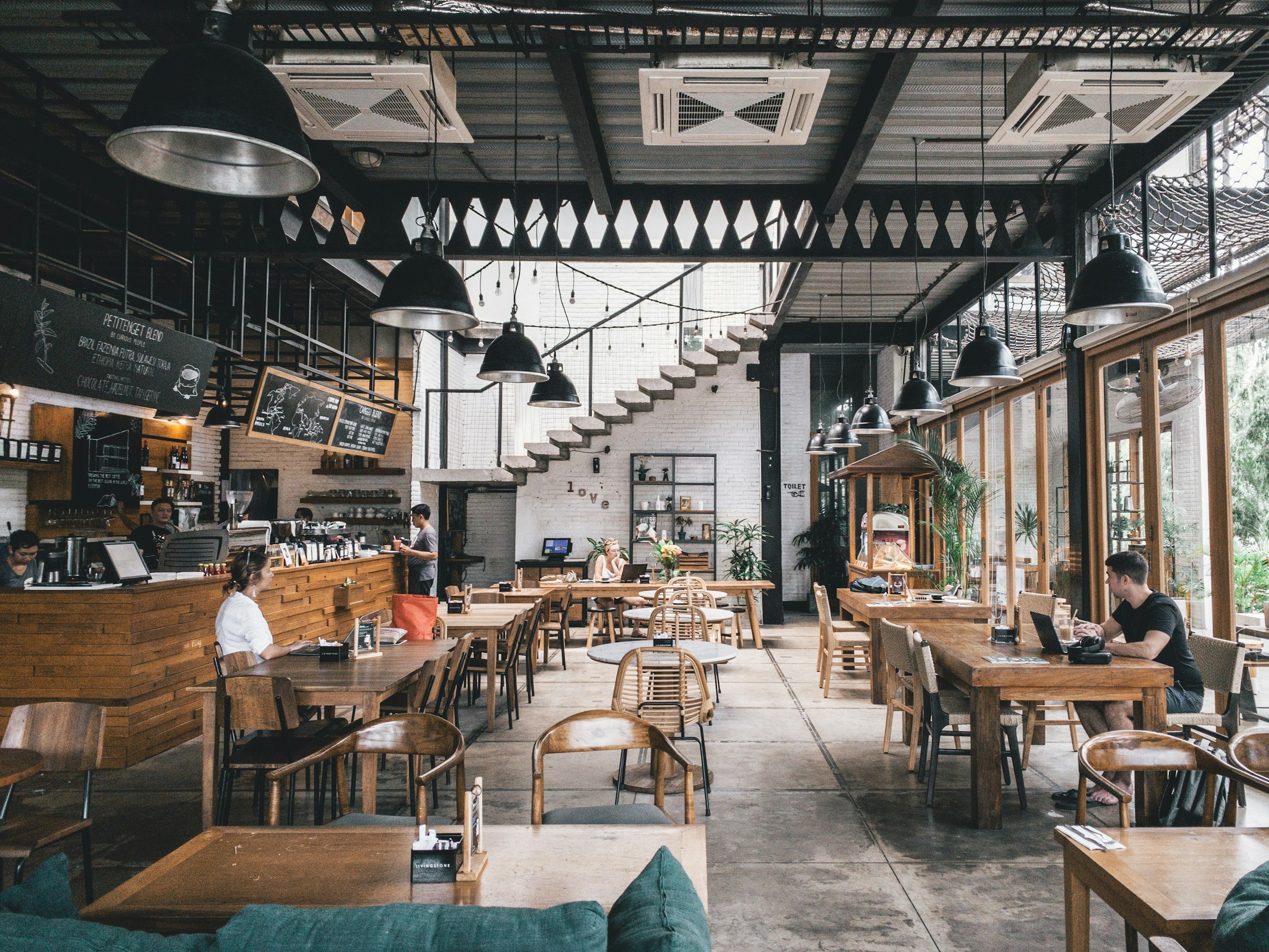 Inside Maple & Thyme: long wooden tables in warm light